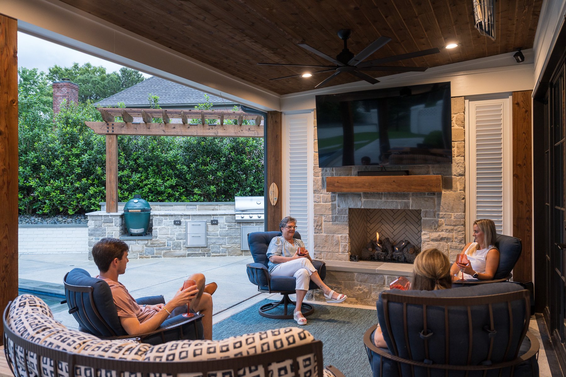 customers party covered patio fireplace outdoor kitchen