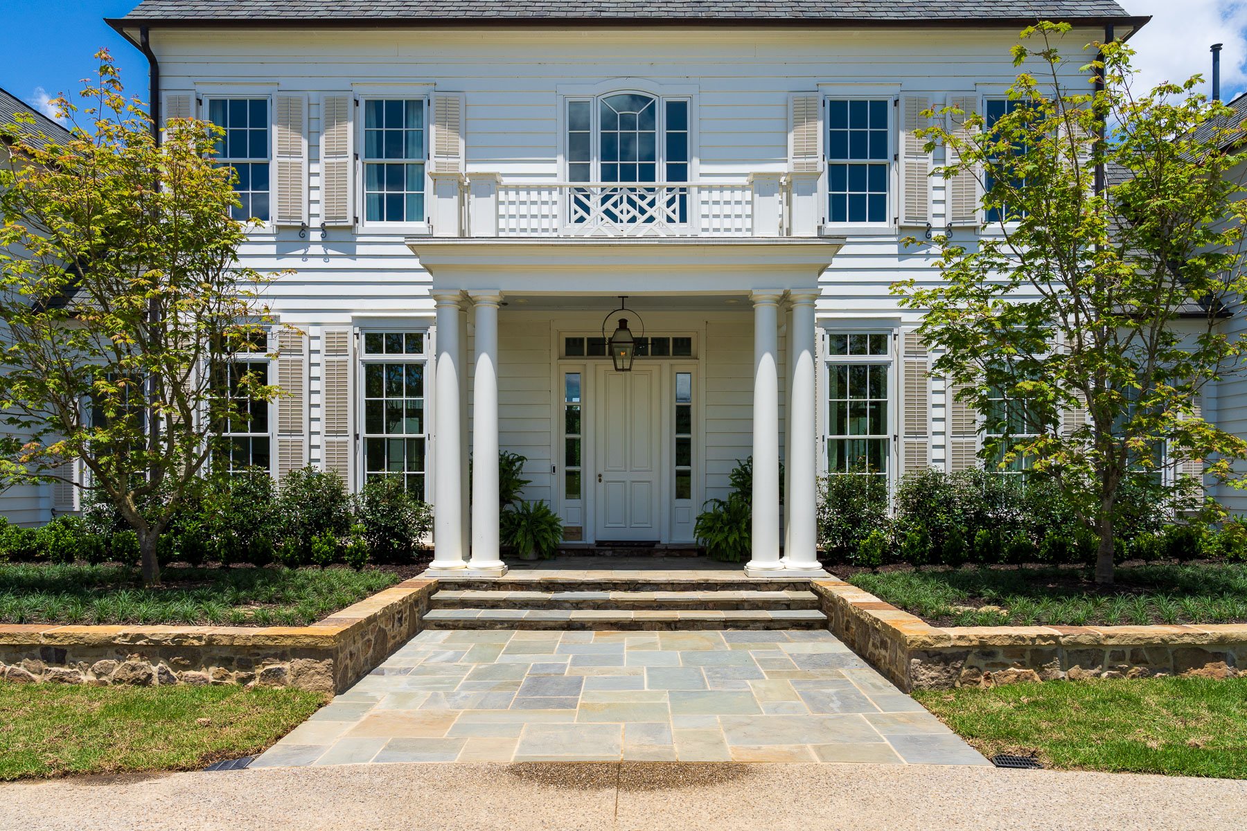 home entry stone wall steps trees drainage patio