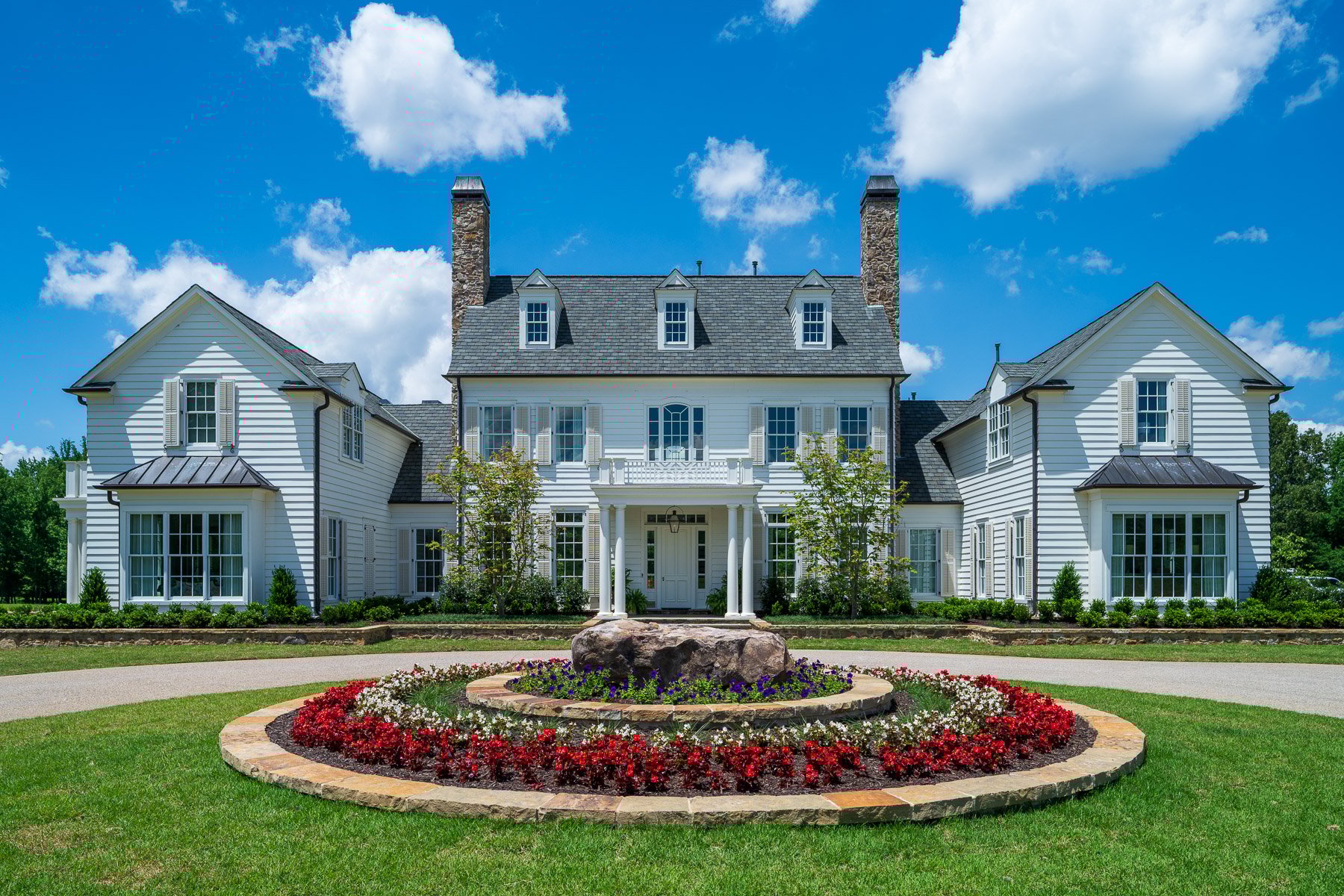 nice flower bed planting bed landscape entry home driveway stone shrubs trees 4