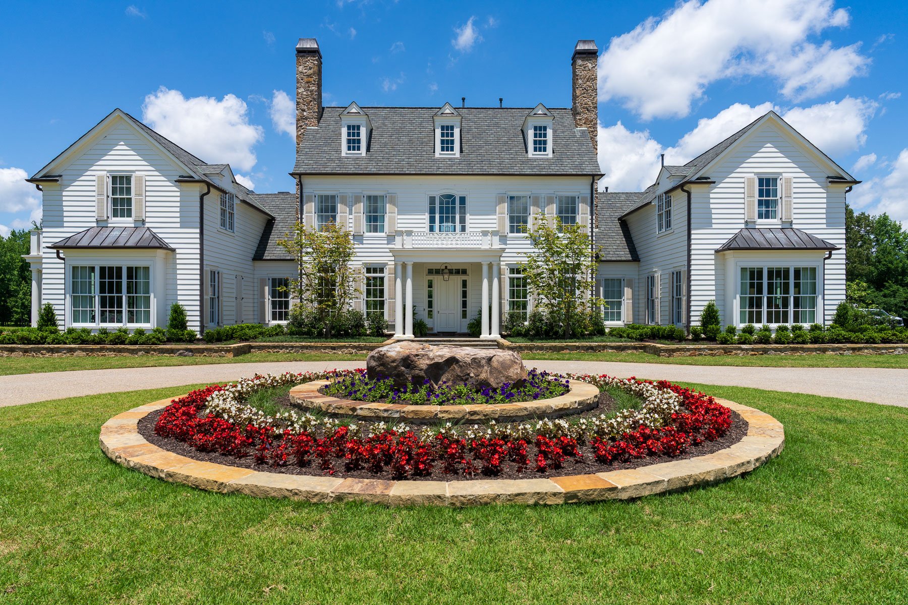 nice flower bed planting bed landscape entry home driveway stone shrubs trees