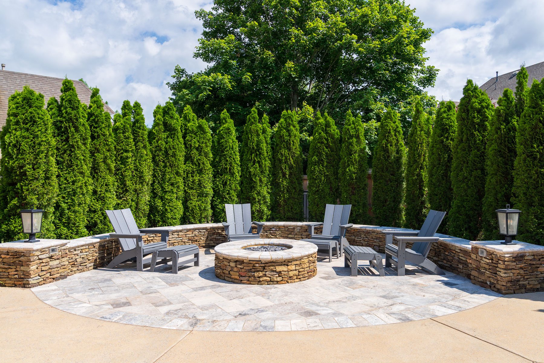 nice patio firepit seating wall lights arborvitae