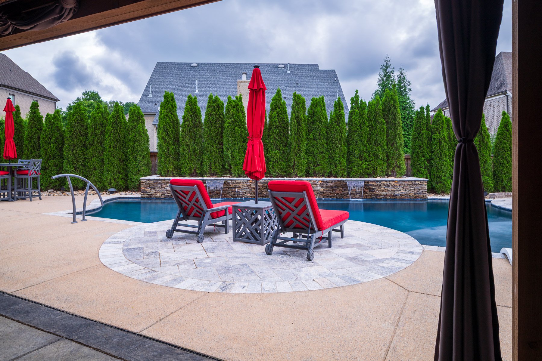 seating patio umbrella pool arborvitae